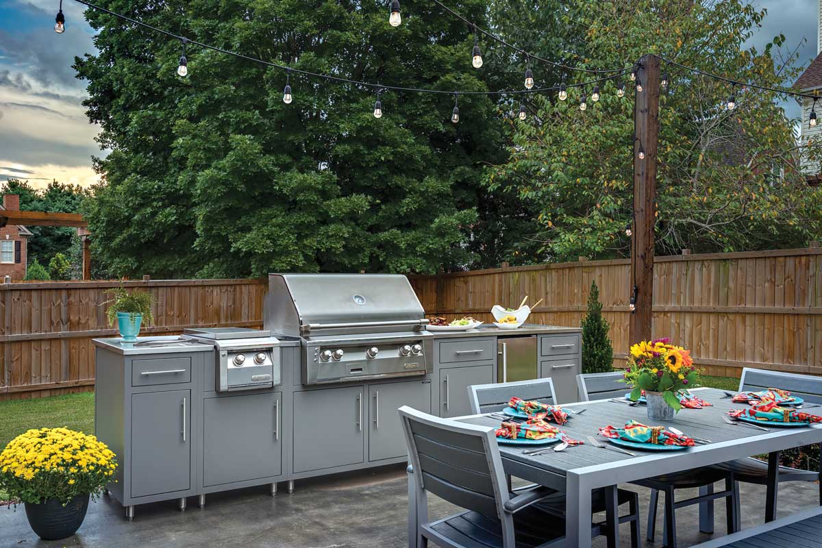 Cooking outdoor space- Patio with large grill and outdoor kitchen featuring cabinets and stainless counters.